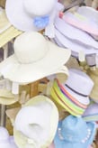 Bright multicolored abstract of womens sunhats on display in front of shop in Florida, for themes of fashion, tourism, retail