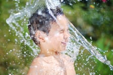 Very cute child playing with water outdoor