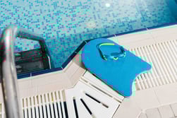 top-view-of-swim-goggles-on-flutter-board-near-swi-2023-11-27-05-09-05-utc